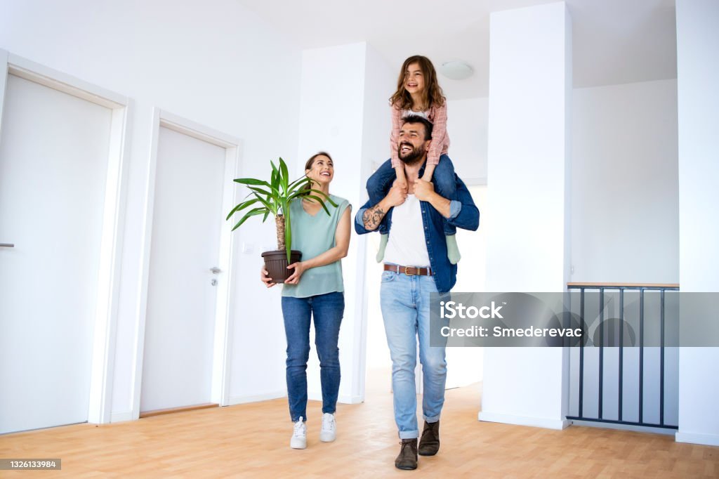 family feeling excited while moving into new house.