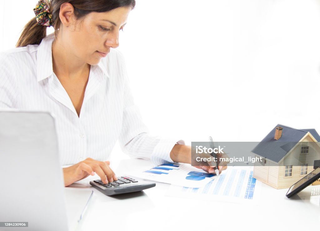 business woman calculating home loan in office